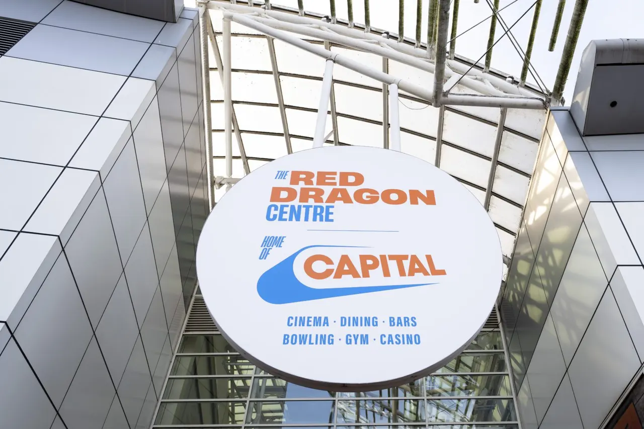 Circular hanging sign for The Red Dragon Centre displaying venue amenities including cinema, dining, bowling, gym and casino.