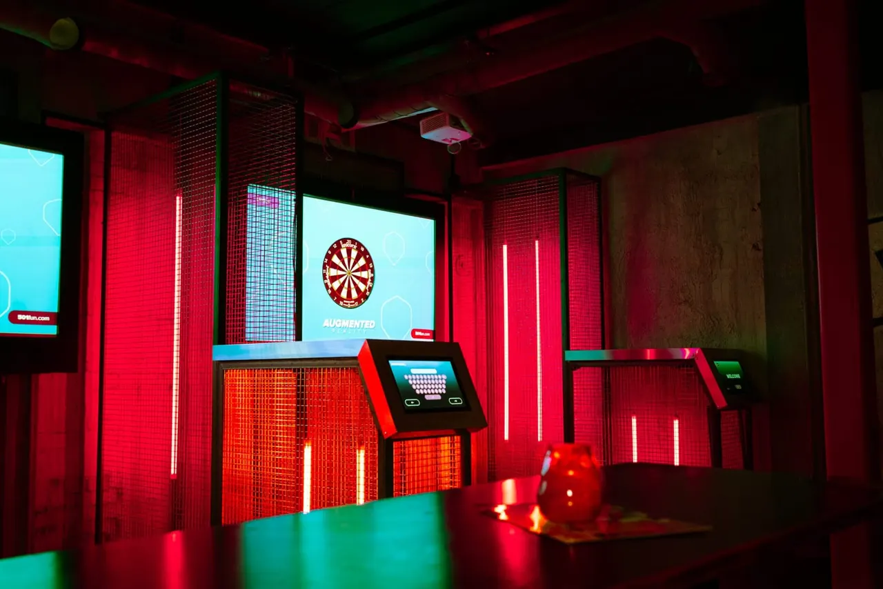 Augmented reality darts bay with neon mesh cage at Golf Fang Nottingham