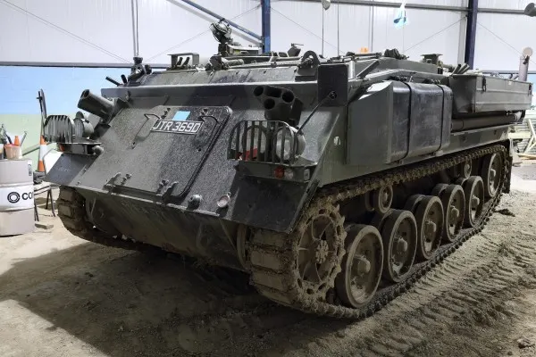 Military tracked armoured personnel carrier displayed outdoors at a museum.