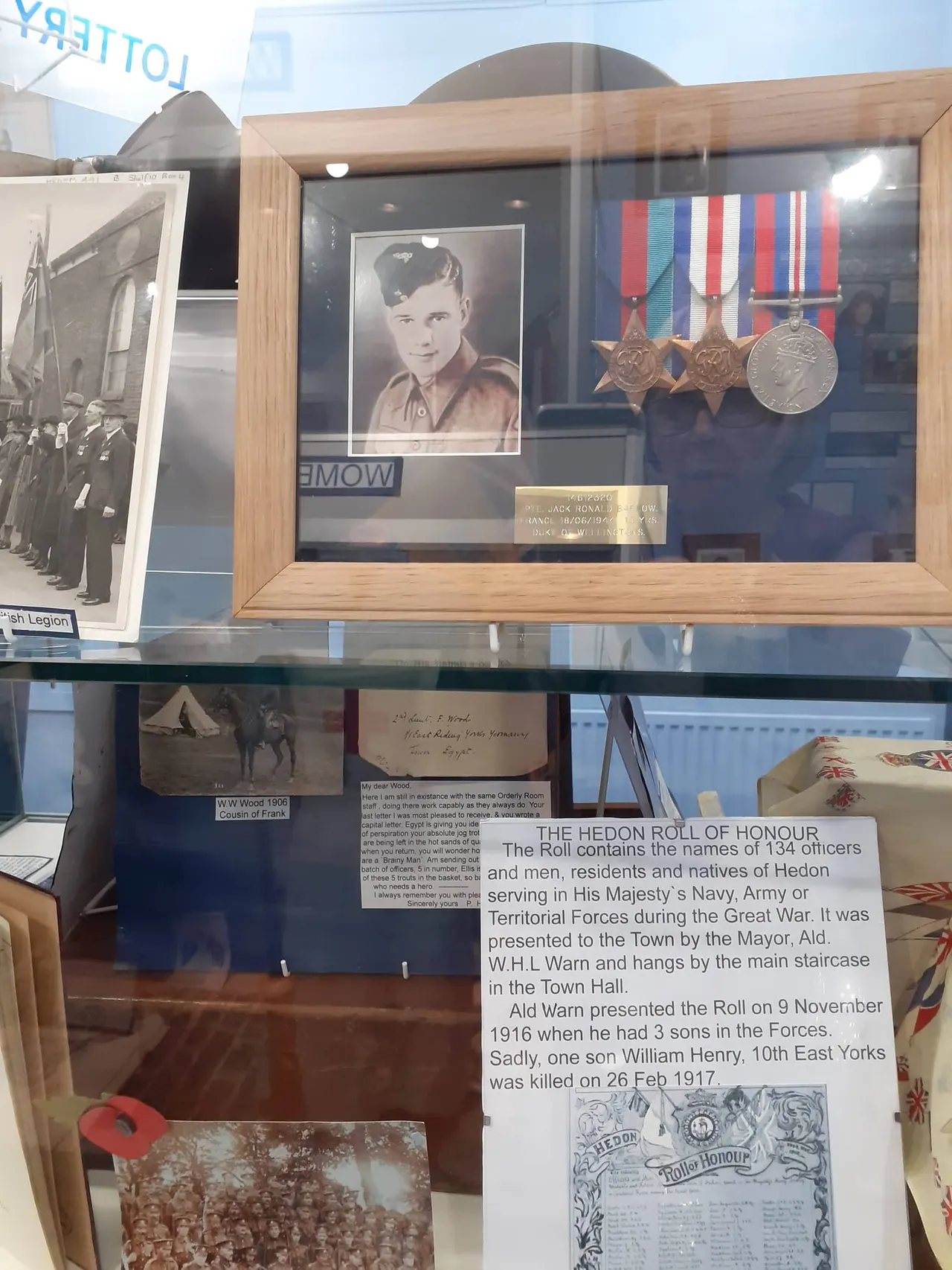 Display cabinet containing a military portrait, medals and ribbons, and historical documents relating to World War One servicemen from Hedon.
