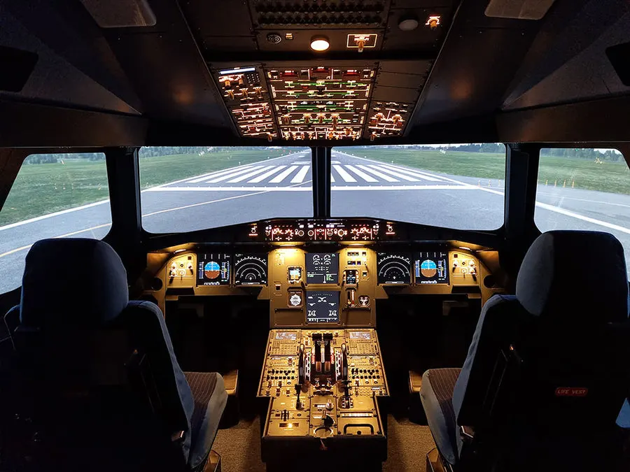 Aircraft cockpit simulator view with runway visible through windscreen ahead.