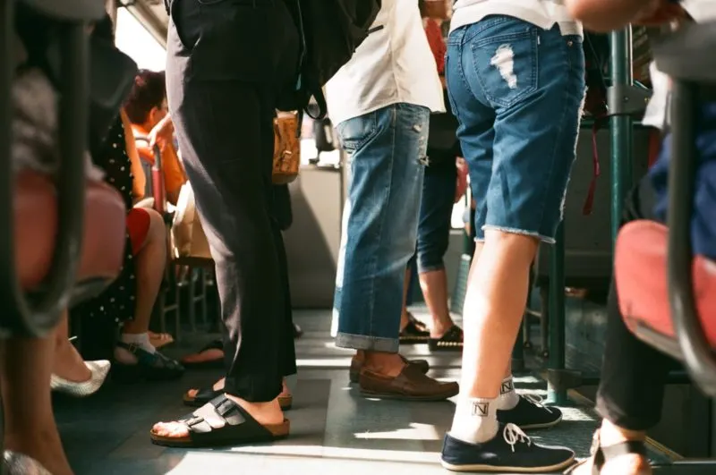 People standing closely together inside a vehicle or confined space.
