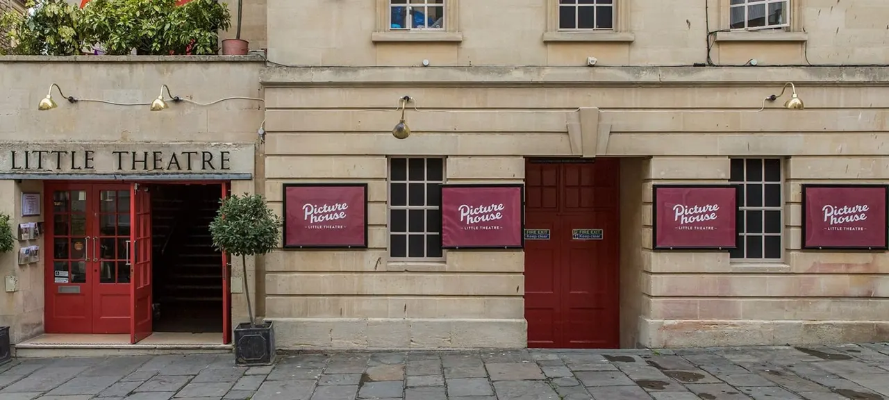 Historic stone building with red doors and burgundy signage for Little Theatre and Picture House cinema.
