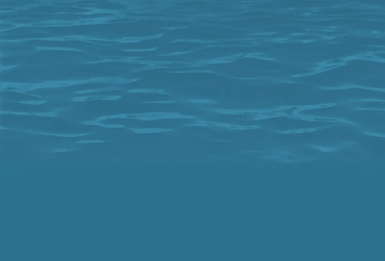 Clear bright blue water with rippling surface.