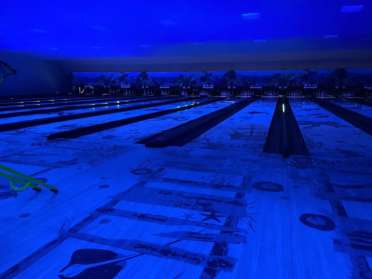 Bowling lanes in darkness with coloured lane lights at Mansfield Superbowl