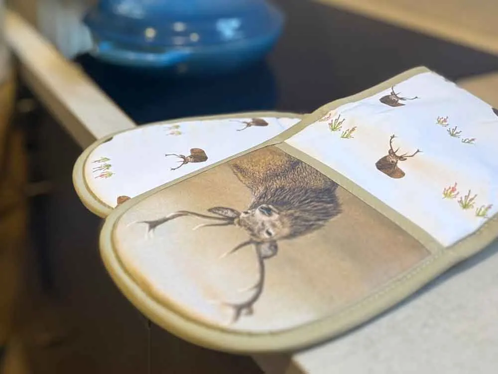 Open illustrated book with drawings of a hedgehog and woodland creatures on display.