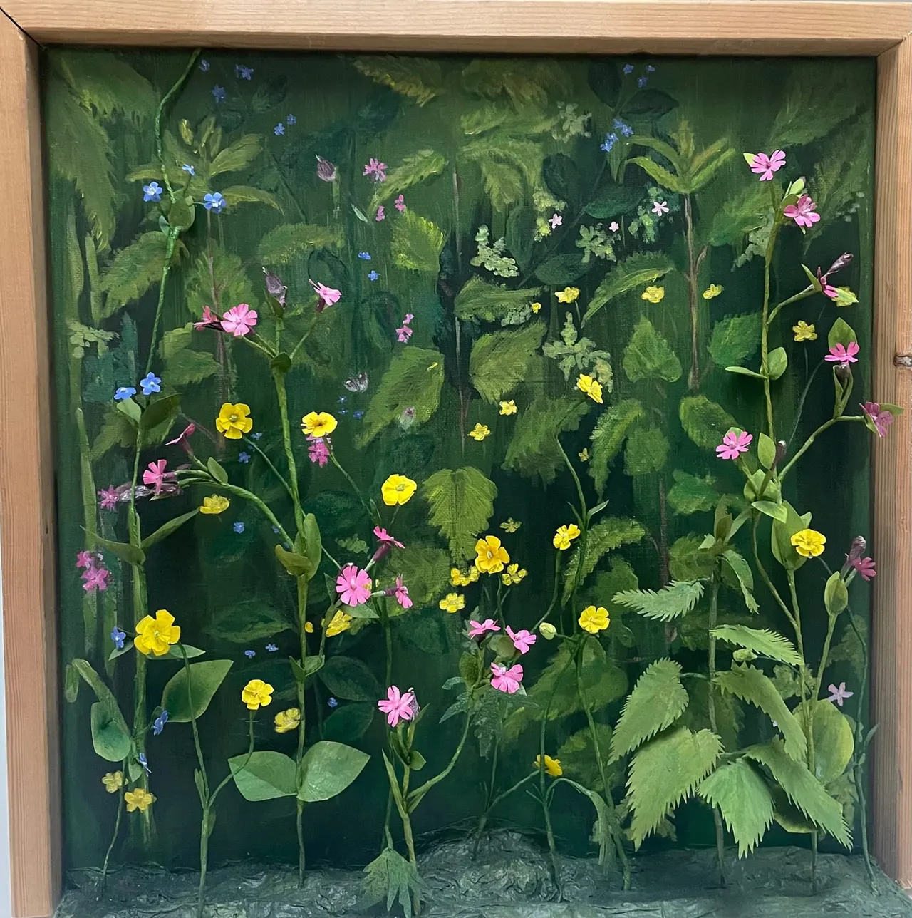 Painted artwork depicting a lush garden scene with various wildflowers in pink, yellow and blue among green foliage and ferns.