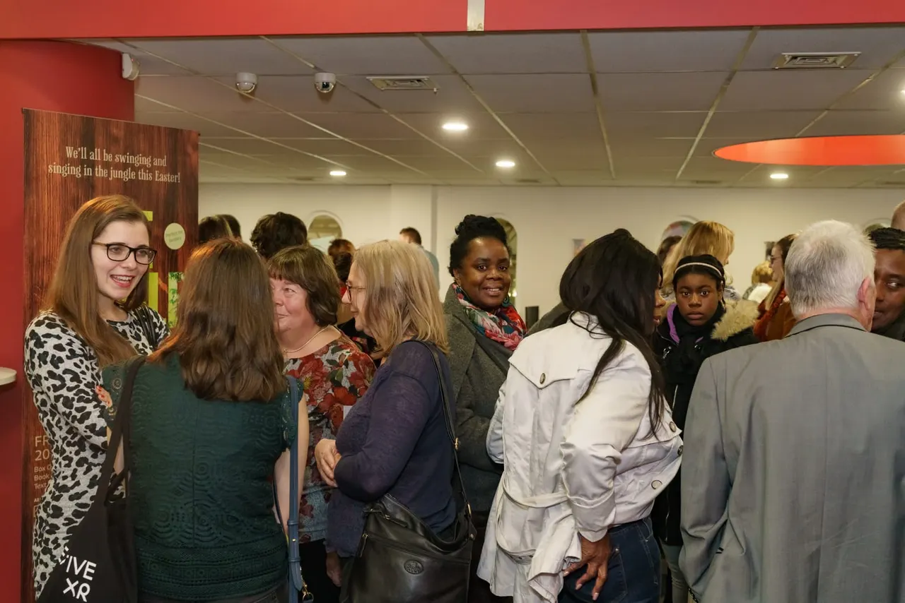 Families queueing in the bright Derby Theatre foyer