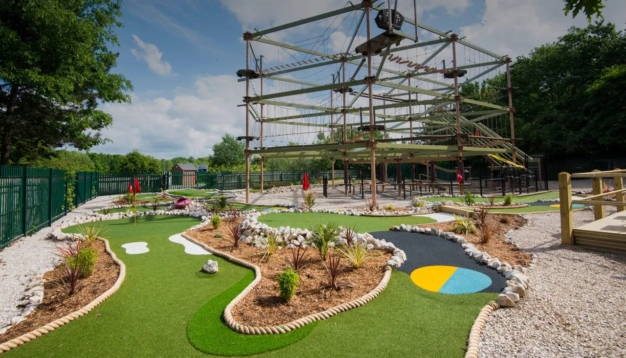 Outdoor mini golf greens under the Sky Trail structure at Holme Pierrepont OAZ