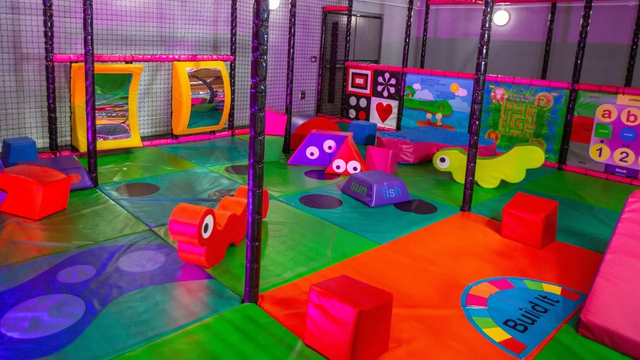 Toddler soft-play enclosure with foam shapes and interactive panels at Lammas
