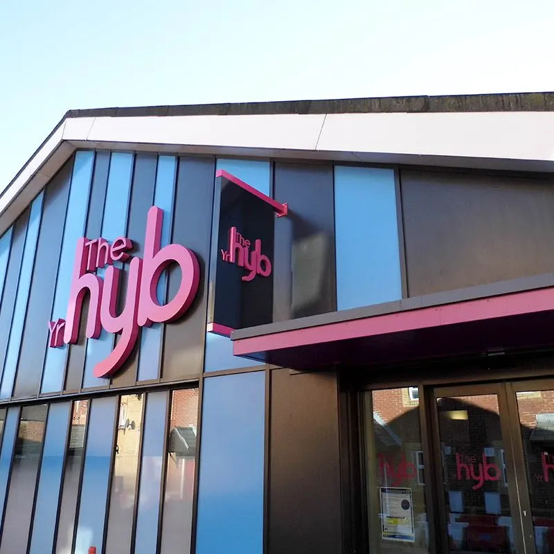 This is a designed graphic (signage/logo on a building facade), so I'll respond accordingly.

GRAPHIC