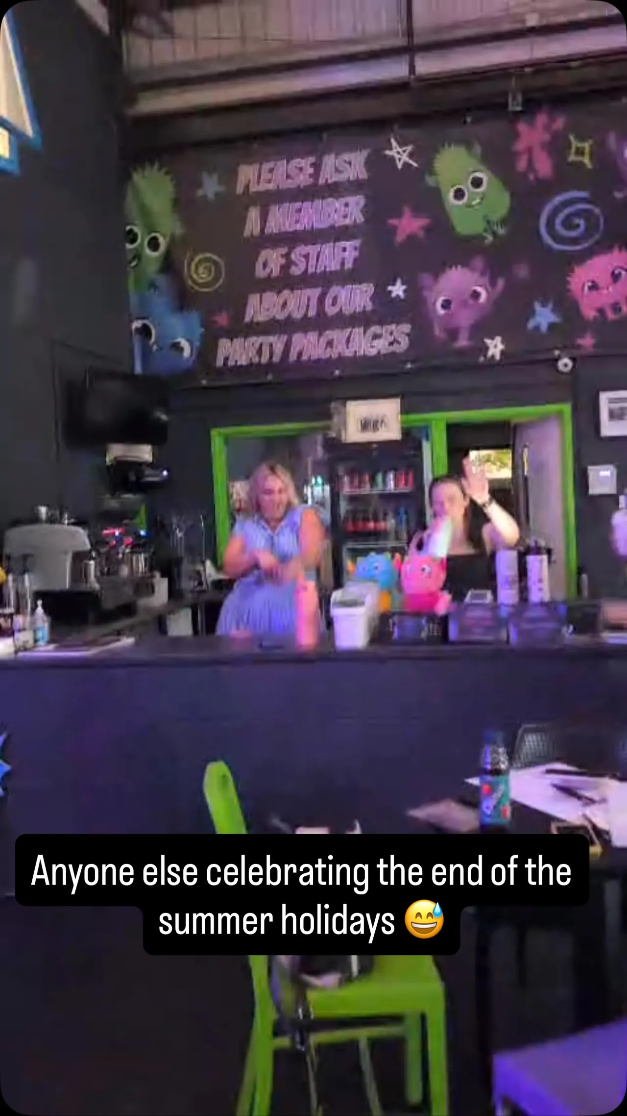 Cafe counter with staff, espresso machine and party packages sign