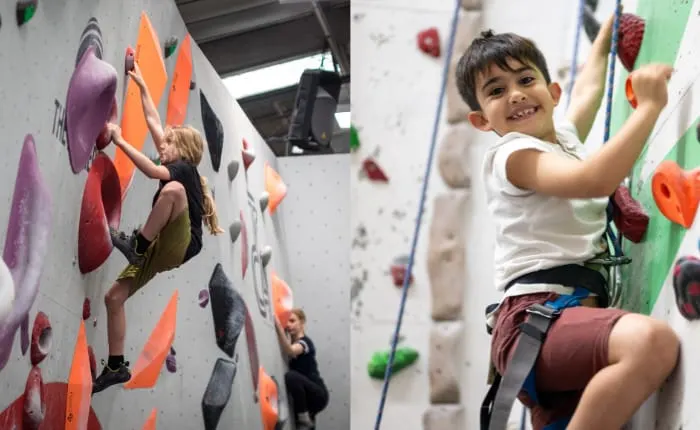 Young children climbing indoor rock walls with various coloured handholds.