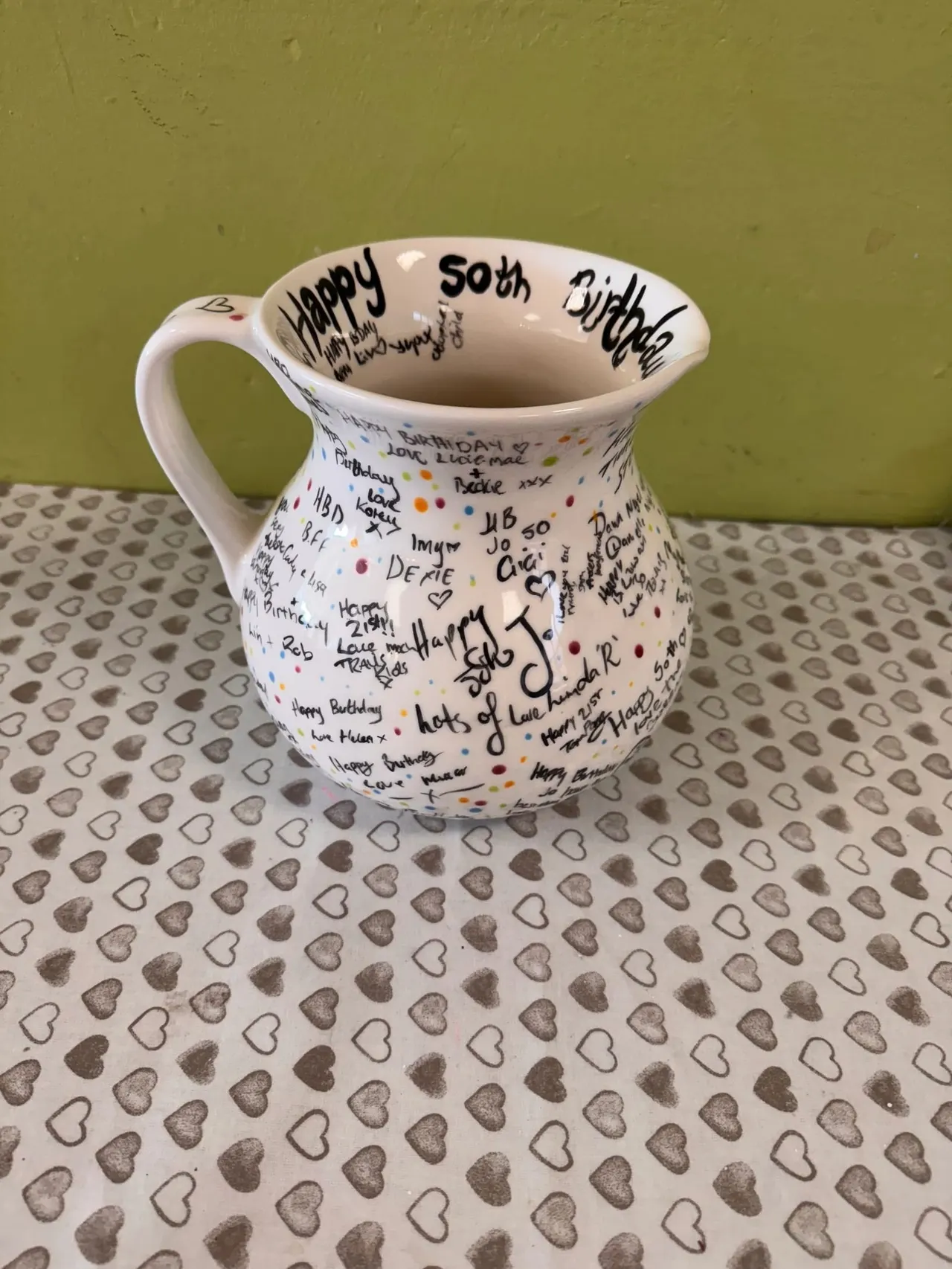 Painted pottery and studio table at Pot N Kettle
