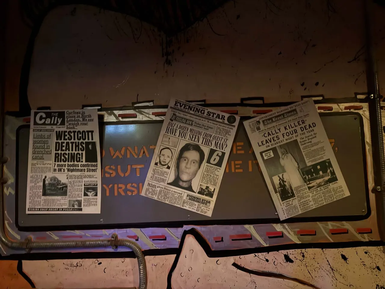 Historic newspaper clippings and headlines displayed in a museum-style case as part of an escape room experience.