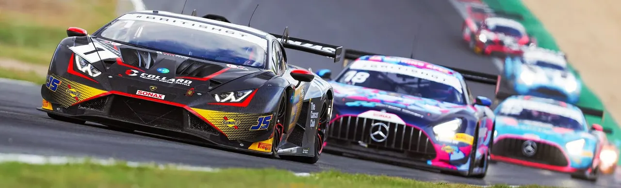 Racing cars competing on track during a motorsport event.
