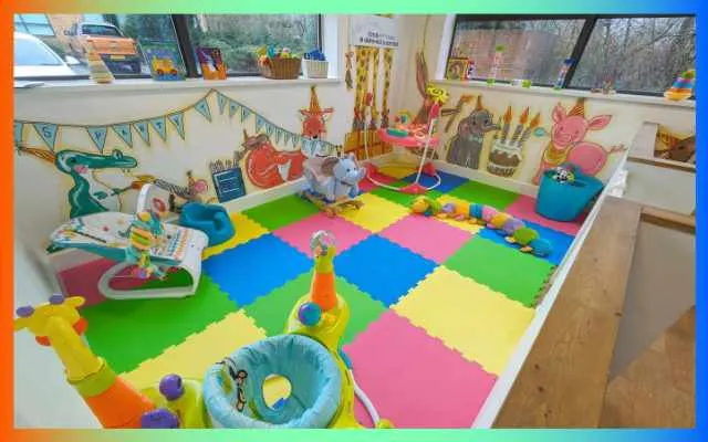 Colourful soft play area for babies and toddlers with foam mats, toys and decorations.