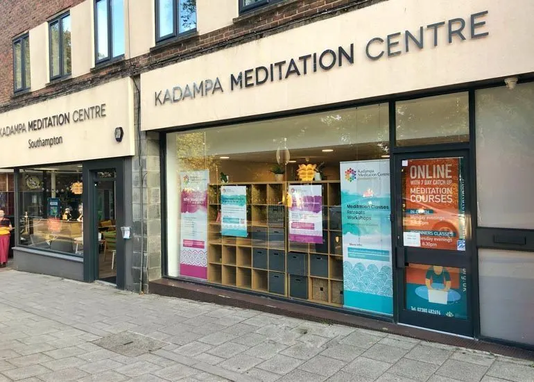 Storefront of Kadampa Meditation Centre in Southampton with display windows showing books, posters and information about meditation courses.