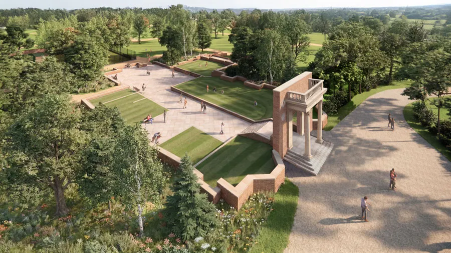 Aerial view of a parkland venue with manicured lawns, pathways, a brick pavilion structure, and visitors scattered across open spaces surrounded by trees.