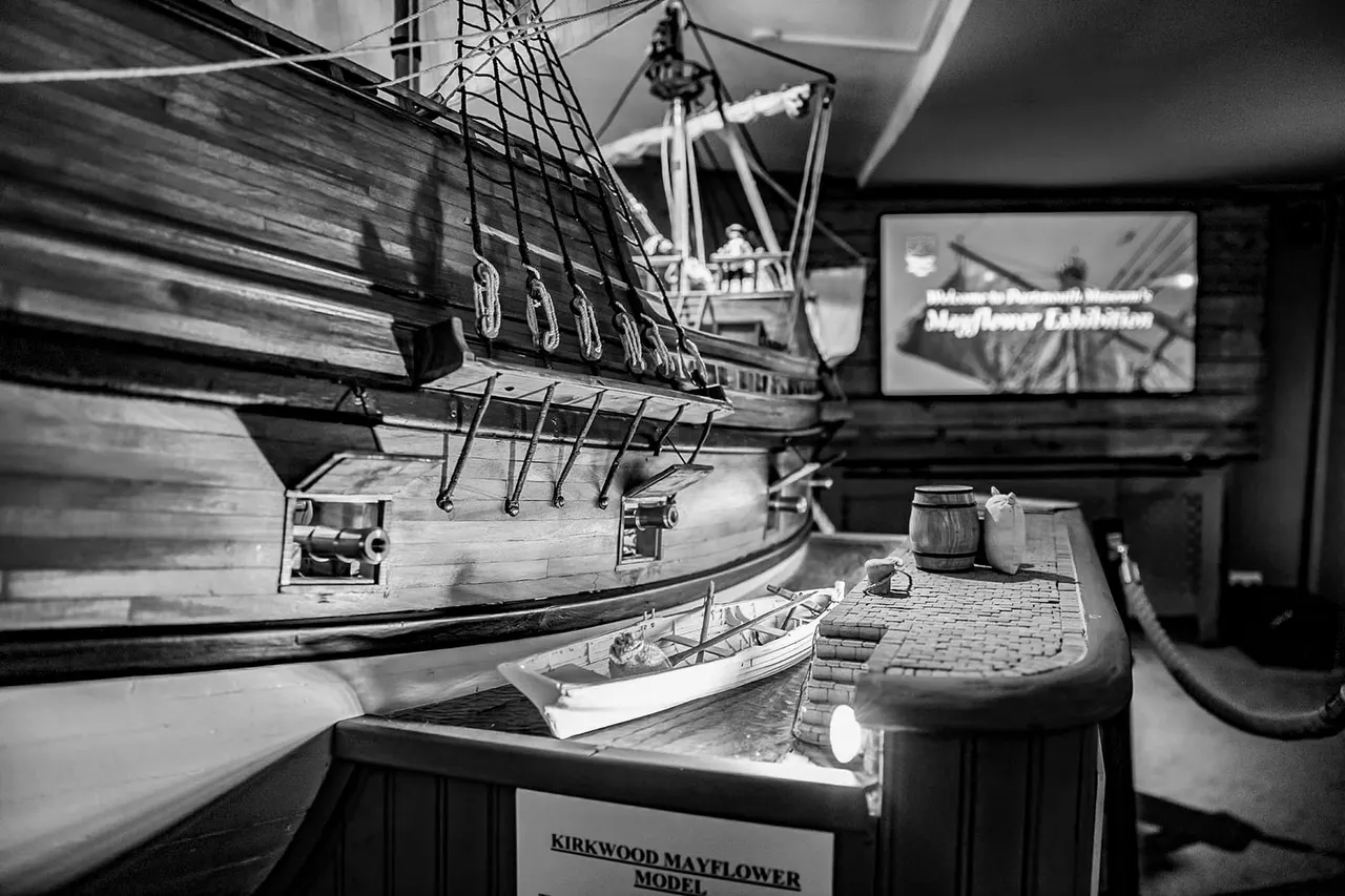 Detailed scale model of the Kirkwood Mayflower ship displayed in a museum exhibition, shown in black and white.