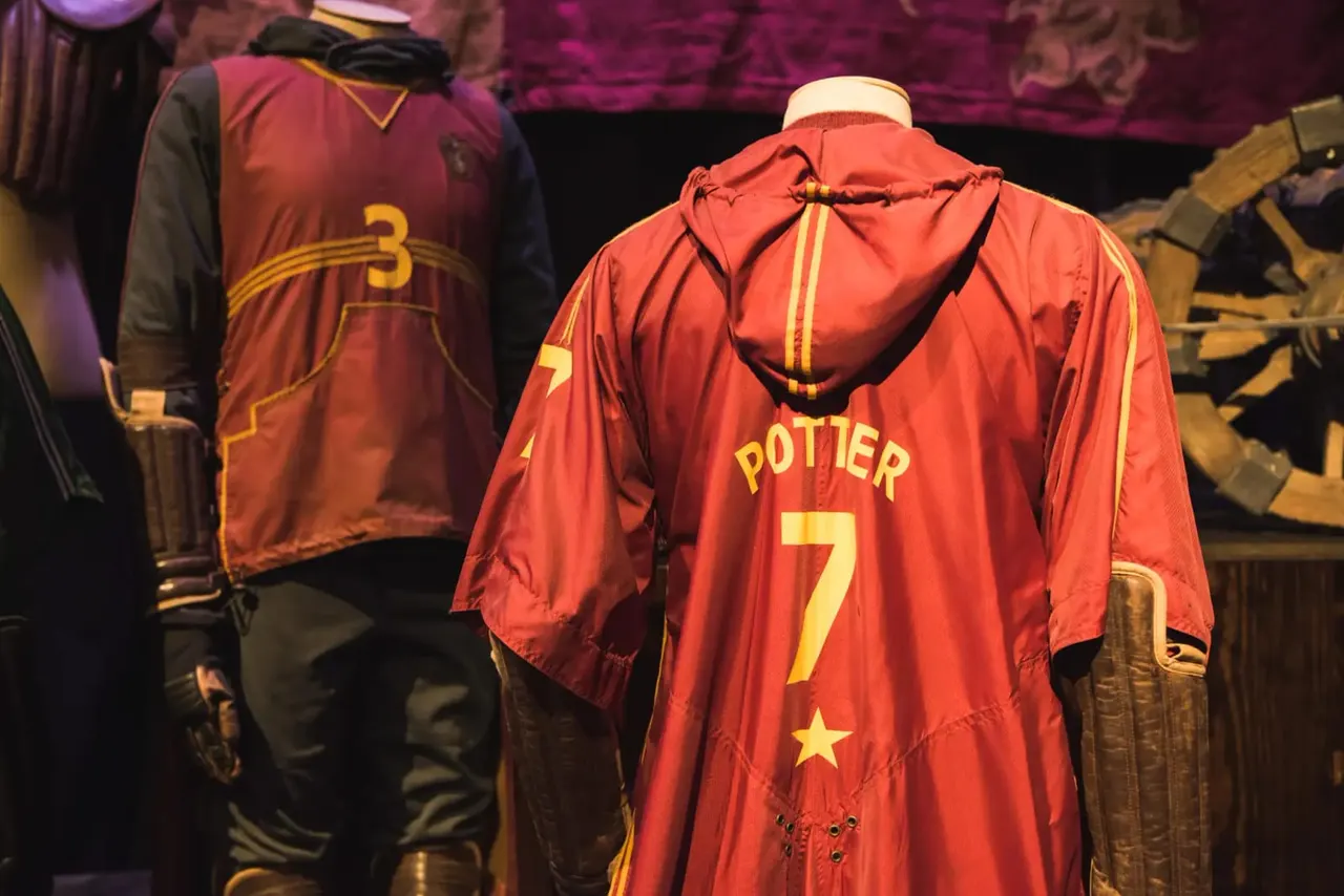 Display of Harry Potter character Quidditch robes, including a red and gold Gryffindor robe with "Potter 7" on the back.