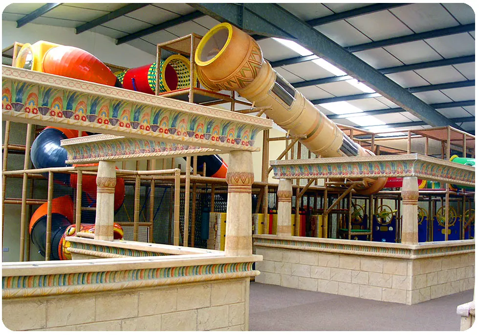 Indoor soft play area with Egyptian-themed décor, featuring colourful slides, tunnels and play structures for children.