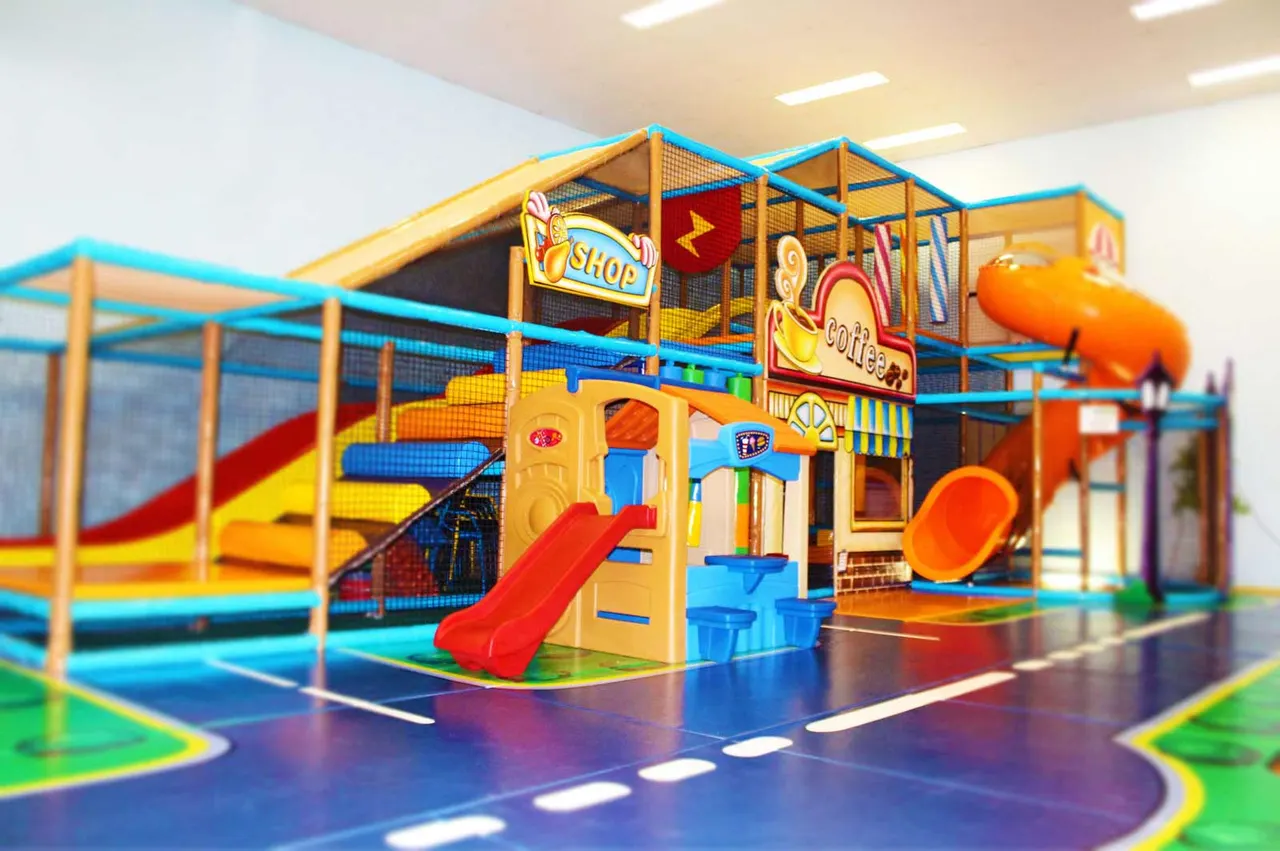 Multi-level soft play frame with slides, climbing nets and padded floors at Jangos Indoor Play Centre