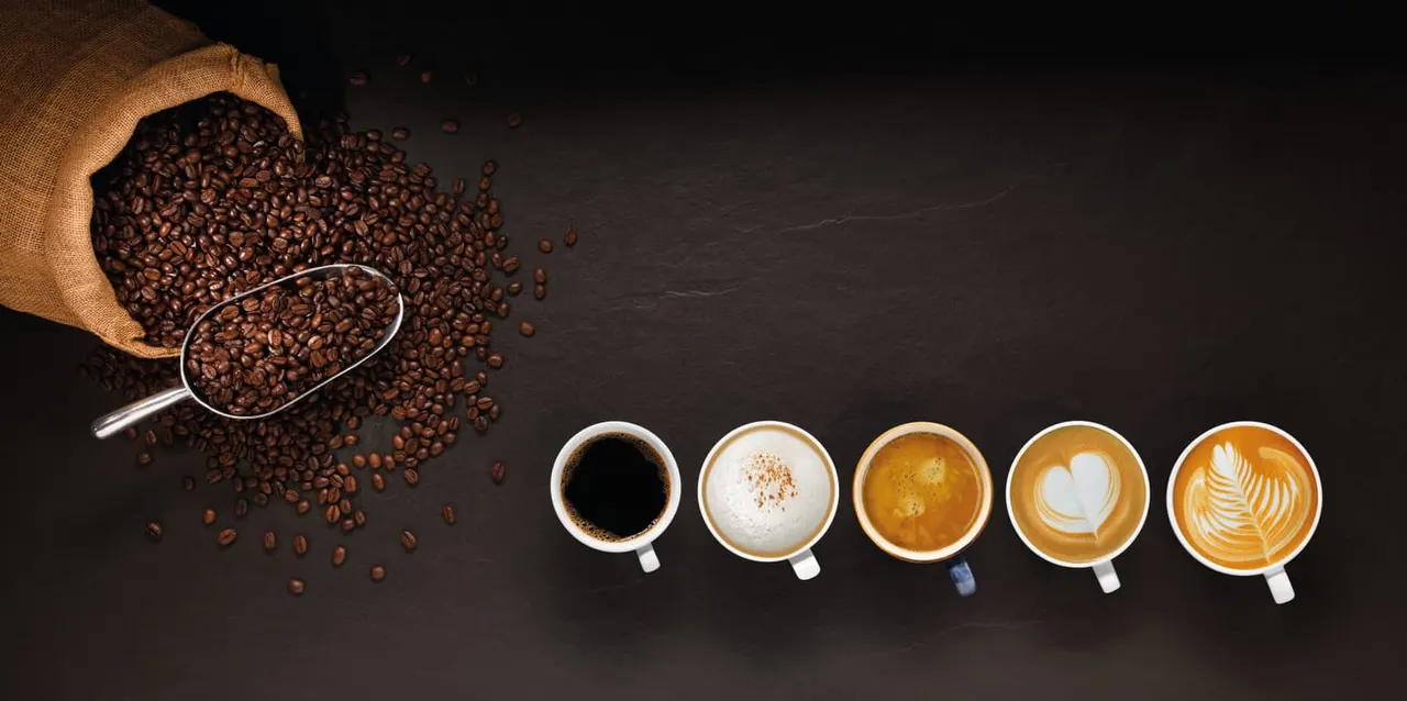 Coffee beans spilling from a burlap sack with a scoop, and five cups showing different coffee preparations with latte art.